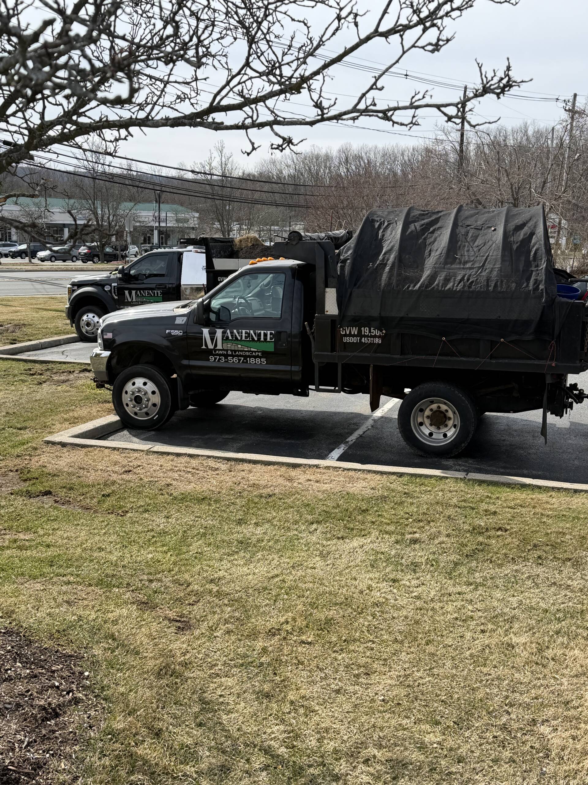 Manente Lawn and Landscape work trucks in Oak Ridge New Jersey after a leaf clean up